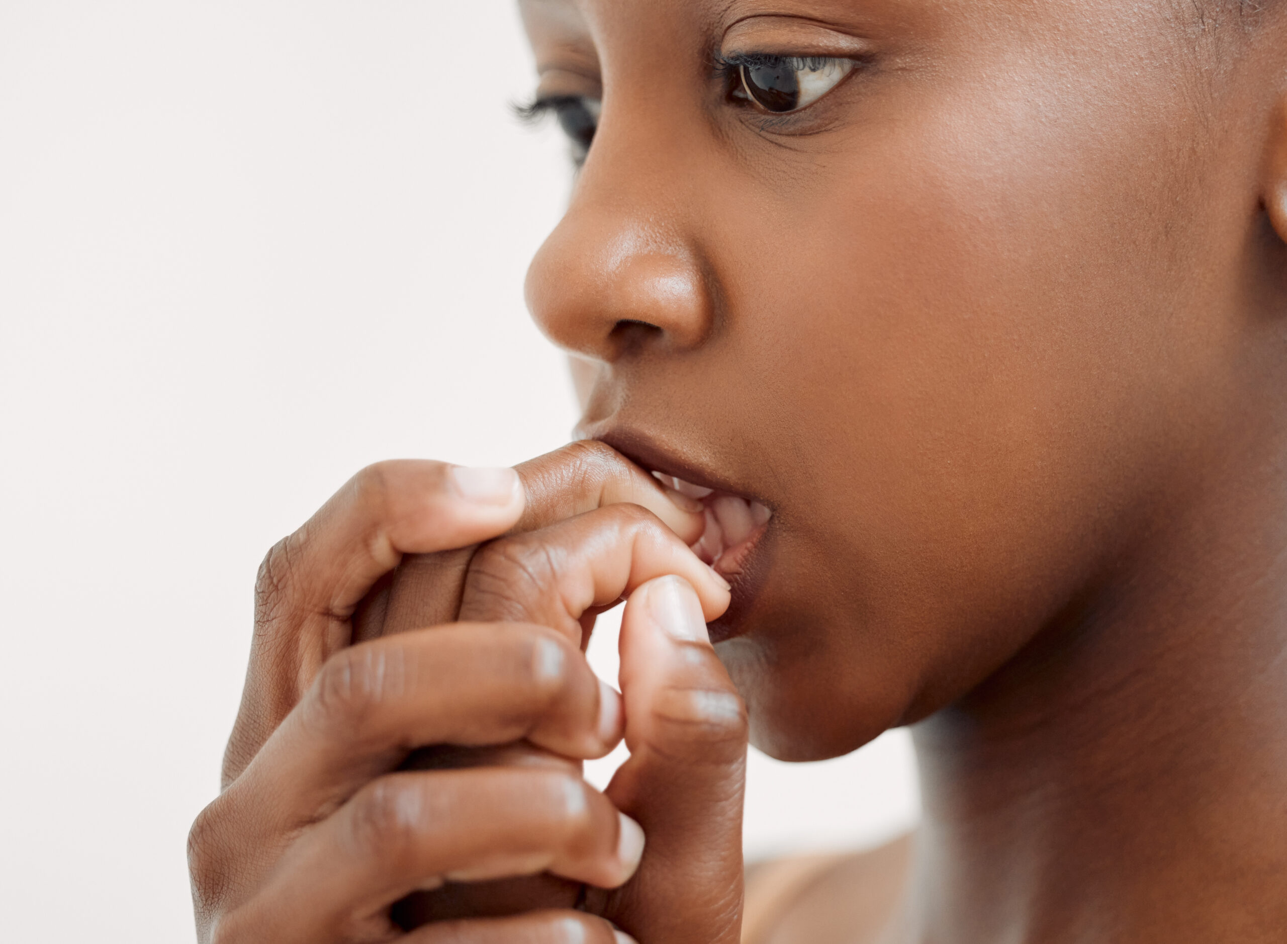 A photo of a young girl nervously biting her nails