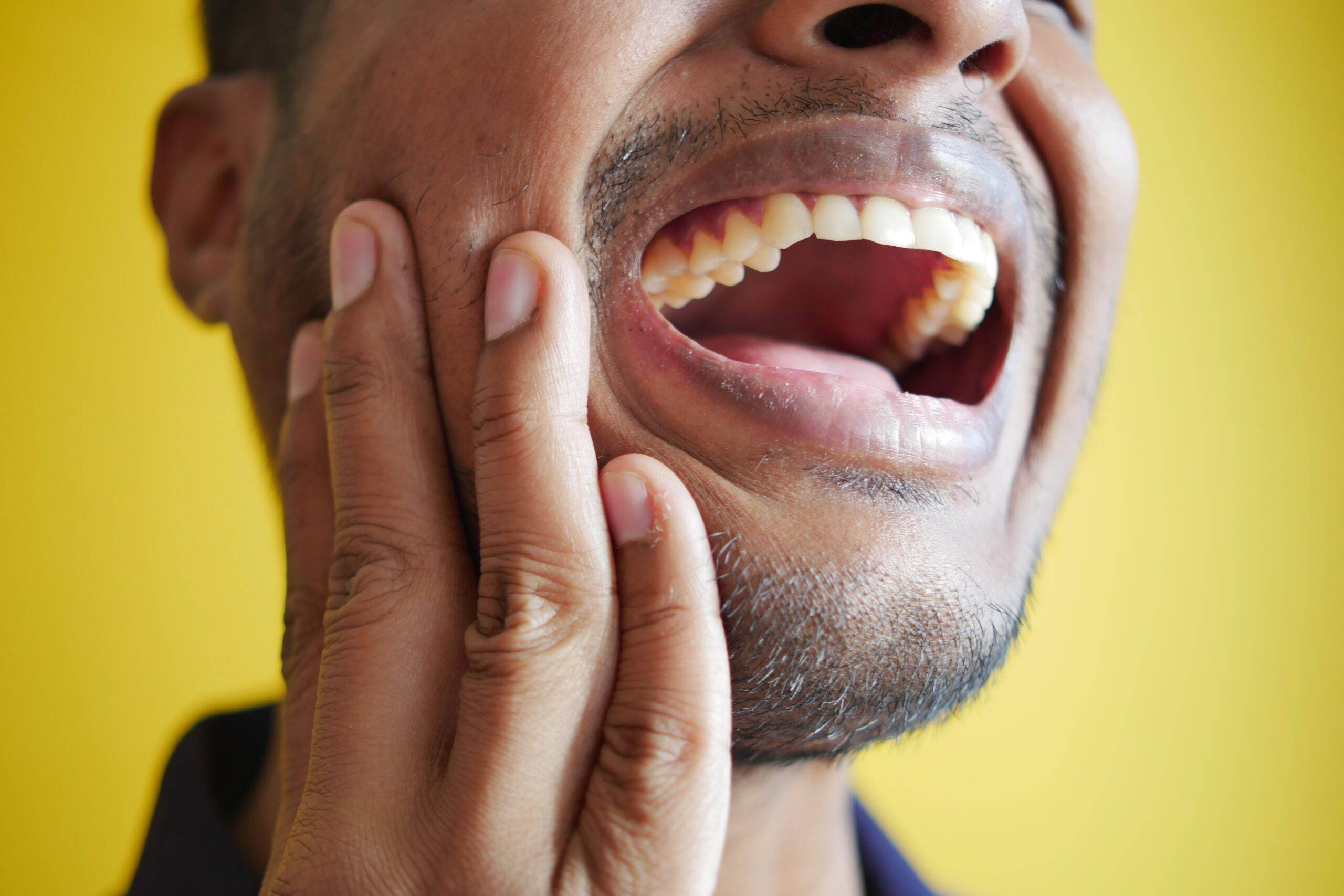 A photo of an individual who is suffering from TMJ and getting OMT to help resolve the issue